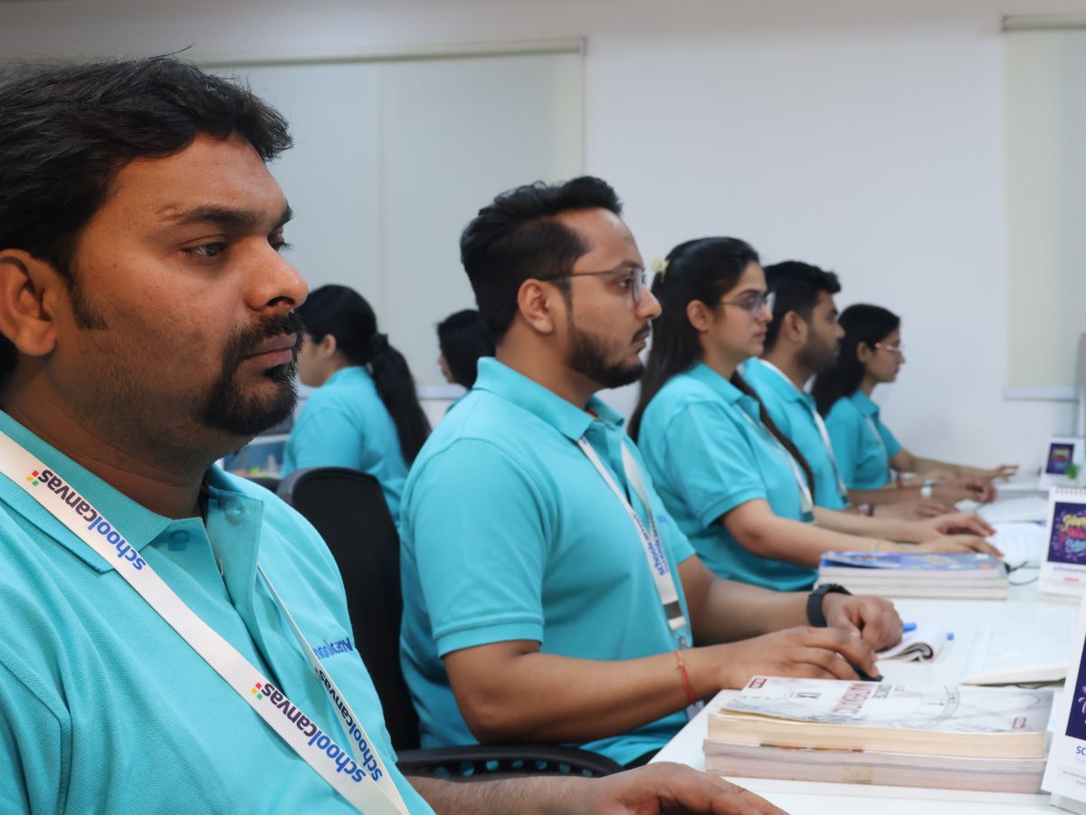 Staff working in a row at their computers in an office